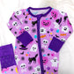 Purple Halloween-themed baby onesie with colorful graphics on a white background